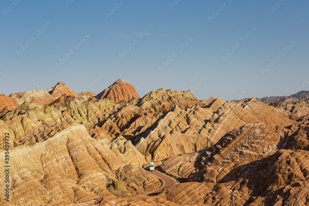 beautiful hilly landscape and bus through winding road in zhangye