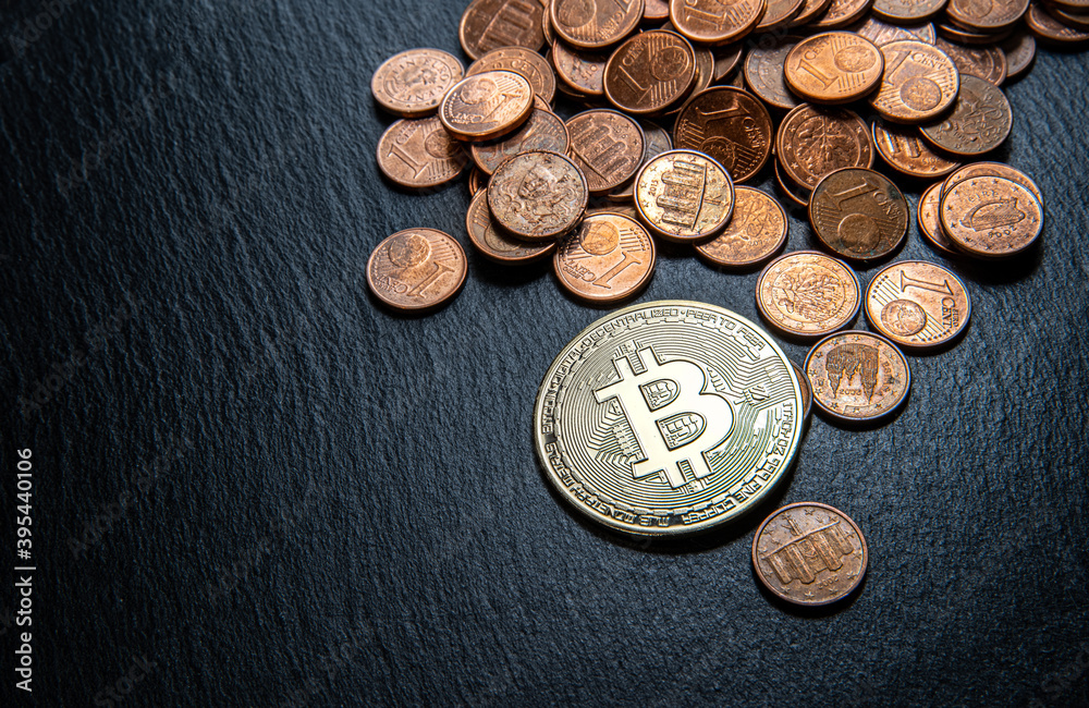Shiny gold, silver and copper bitcoin coins lying and separated on a dark black flat slate stone. Shiny gold, silver and copper bitcoin coins lying and separated on a dark black flat slate stone.