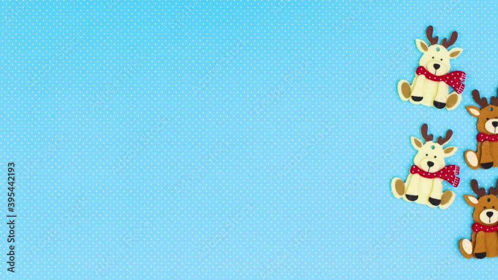 Christmas reindeers and wooden ornaments appear on right side of blue theme. Stop motion Christmas reindeers and wooden ornaments appear on right side of blue theme. Stop motion