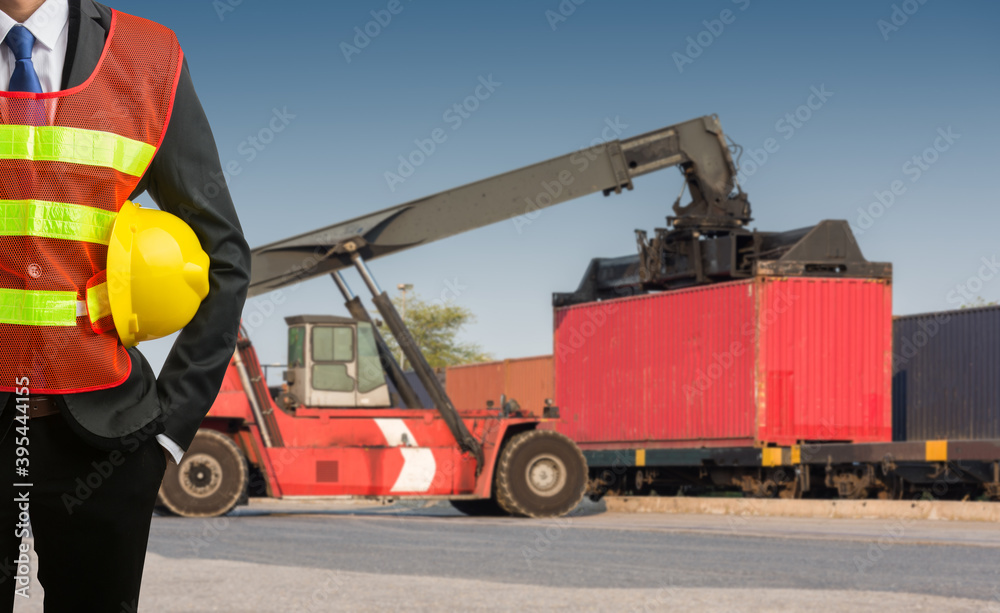 Businessman stand on front forklift loading Containers box to Logistic cargo Import Export Businessman stand on front forklift loading Containers box to Logistic cargo Import Export