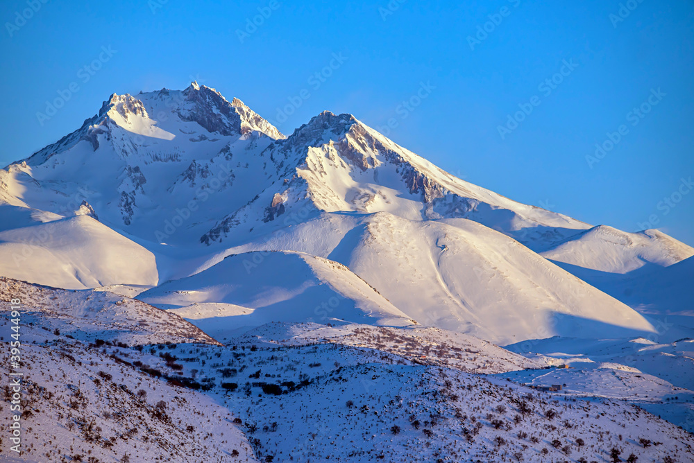 Erciyes Mount with height of 3,864 metres is the highest mountain in Cappadocia and central Anatolia. It is a volcano. Hacilar city - obrazy, fototapety, plakaty 