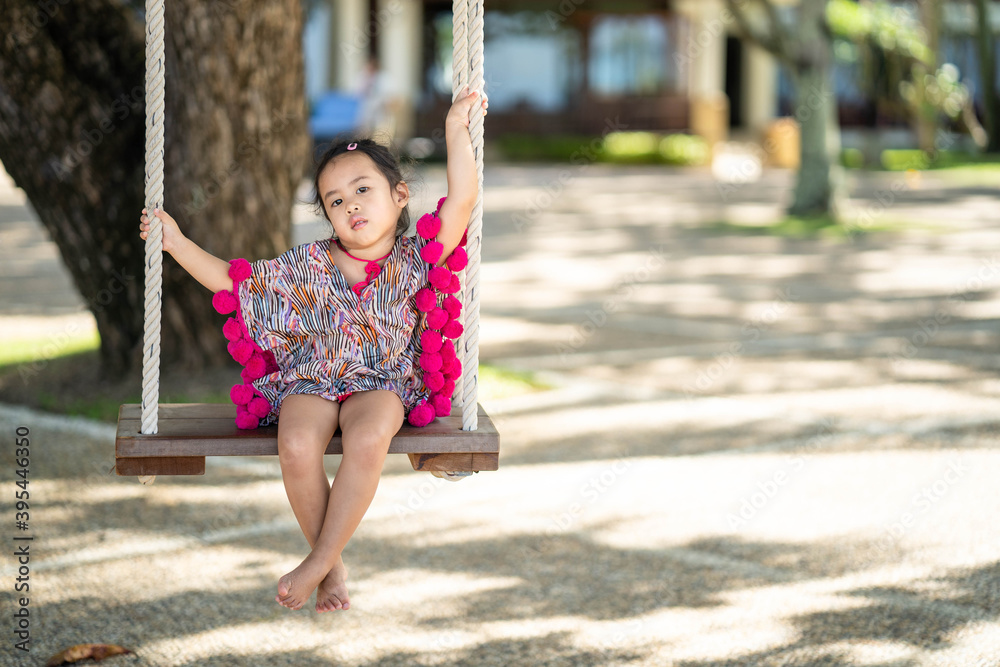 Cute little girl in beautiful dress sitting on swing. Cute little girl in beautiful dress sitting on swing.
