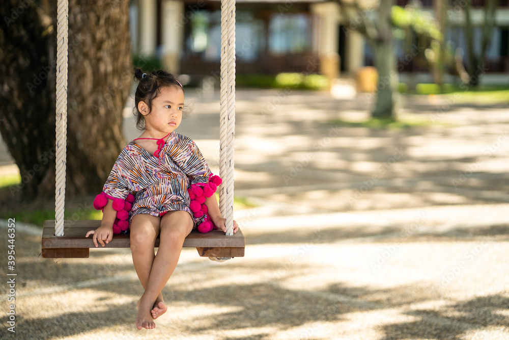 Cute little girl in beautiful dress sitting on swing. Cute little girl in beautiful dress sitting on swing.