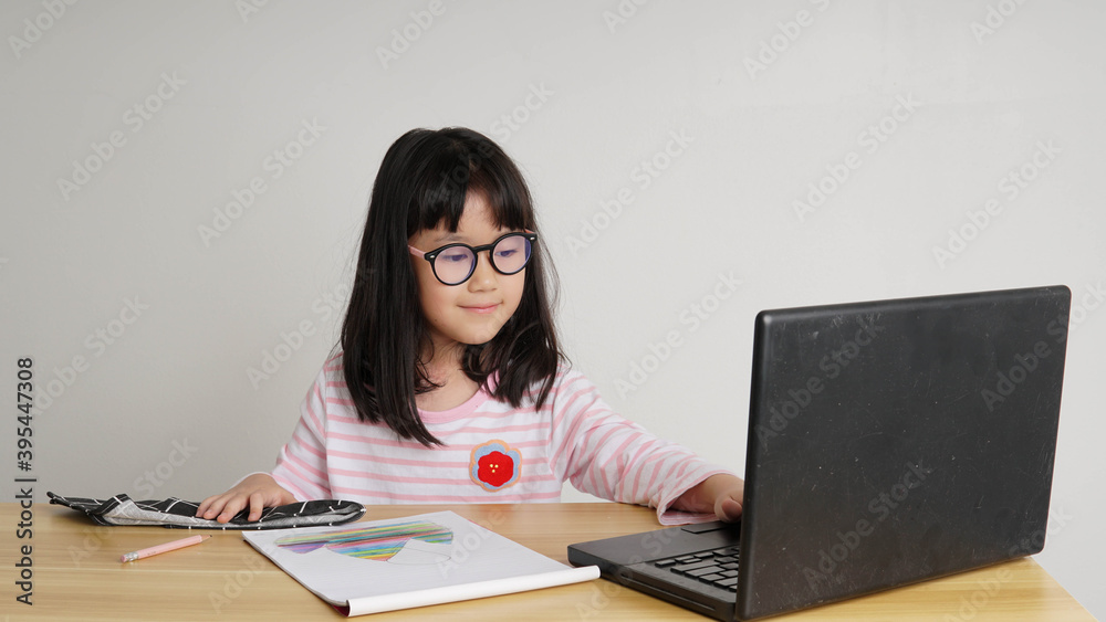 young girl with laptop in front and studying online through remote computer during home quarantine young girl with laptop in front and studying online through remote computer during home quarantine