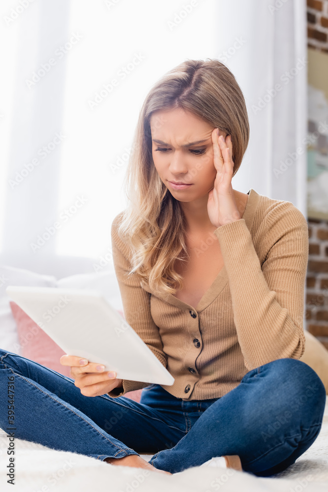 woman with hand near head using digital tablet on bed woman with hand near head using digital tablet on bed