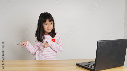 Asian girl learning and K-pop Dance practice from internet course online studying online through remote computer during home quarantine 