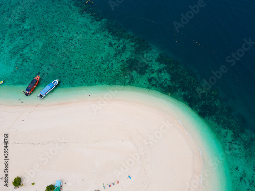 Aerial view of drone. Beaches and shops for food and beverage services on Khai Island, Phuket, Thailand, Seawater clear and blue green. Nature in Khai Island. At Khai island, Phuket, Thailand.
