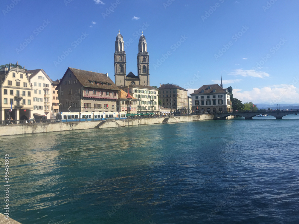 view of the Grossmunster church near river in Zurich, Switzerland, Swiss