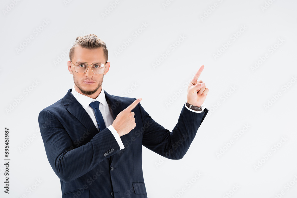 businessman in suit and glasses pointing up isolated on white businessman in suit and glasses pointing up isolated on white