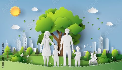 A family enjoys fresh air in the park holding hands together, save the planet and energy concept, paper art, and craft style.