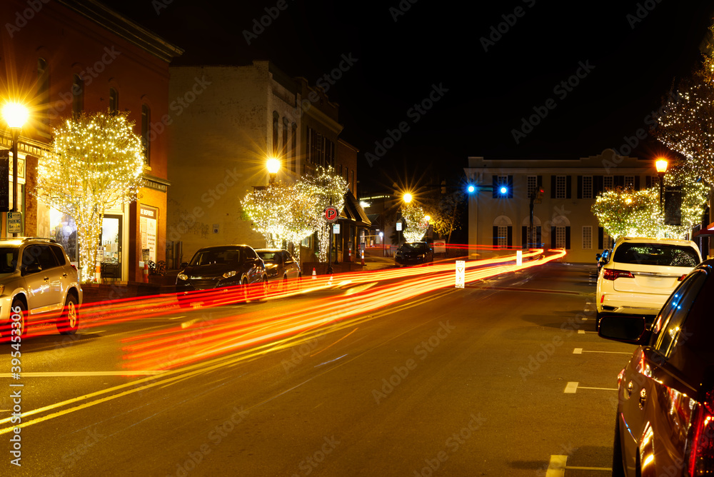 Main street in a small town at Christmas with trees lit.