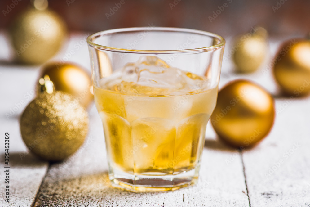 Whiskey on the rocks with winter christmas decorations. Selective focus. Shallow depth of field. Whiskey on the rocks with winter christmas decorations. Selective focus. Shallow depth of field.