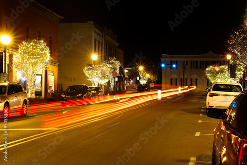 Main street in a small town at Christmas with trees lit. © Joe