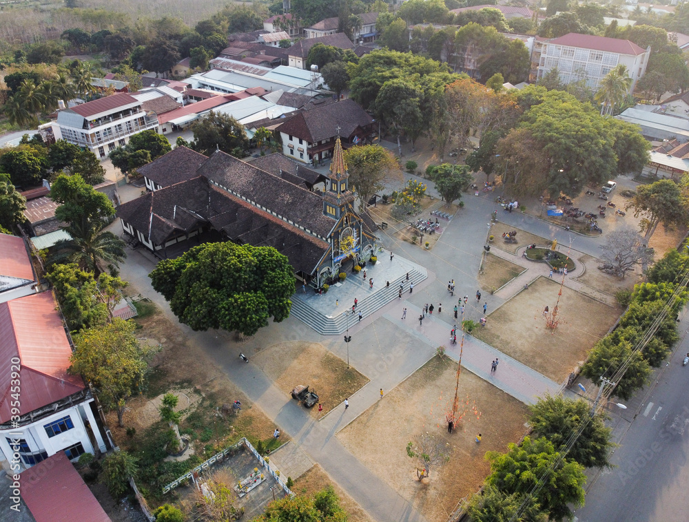Fototapeta premium Aerial view of Go (Wooden) Church in the city of Kon Tum in the Central Highlands of Vietnam is an ancient relic with unique wooden architecture of high aesthetic value