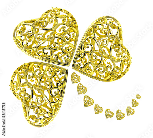 Three-leaf clover made of gold hearts isolated on a white background. Symbol of good luck and wealth.