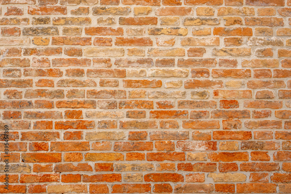Fototapeta premium Background from an old and worn orange brick wall