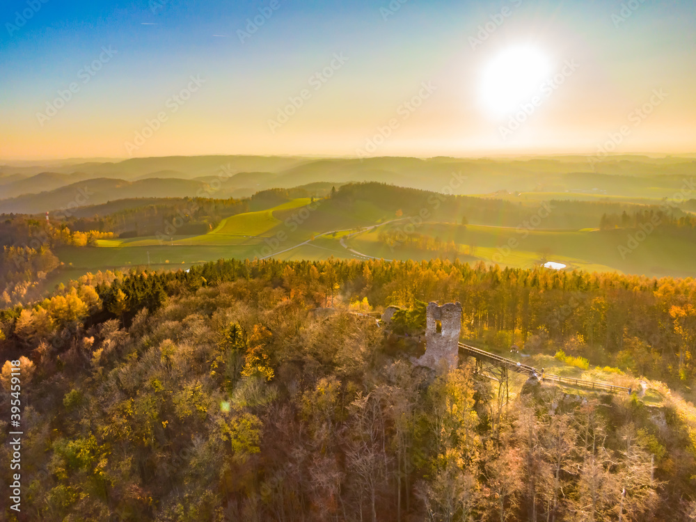 Aerial drone view of ruined castle Zubstejn standing on hill, Czech Republic. Autumn day during the sunset. One of biggest ruins in Czechia. Also known as Zuberstein or Zubstein.
