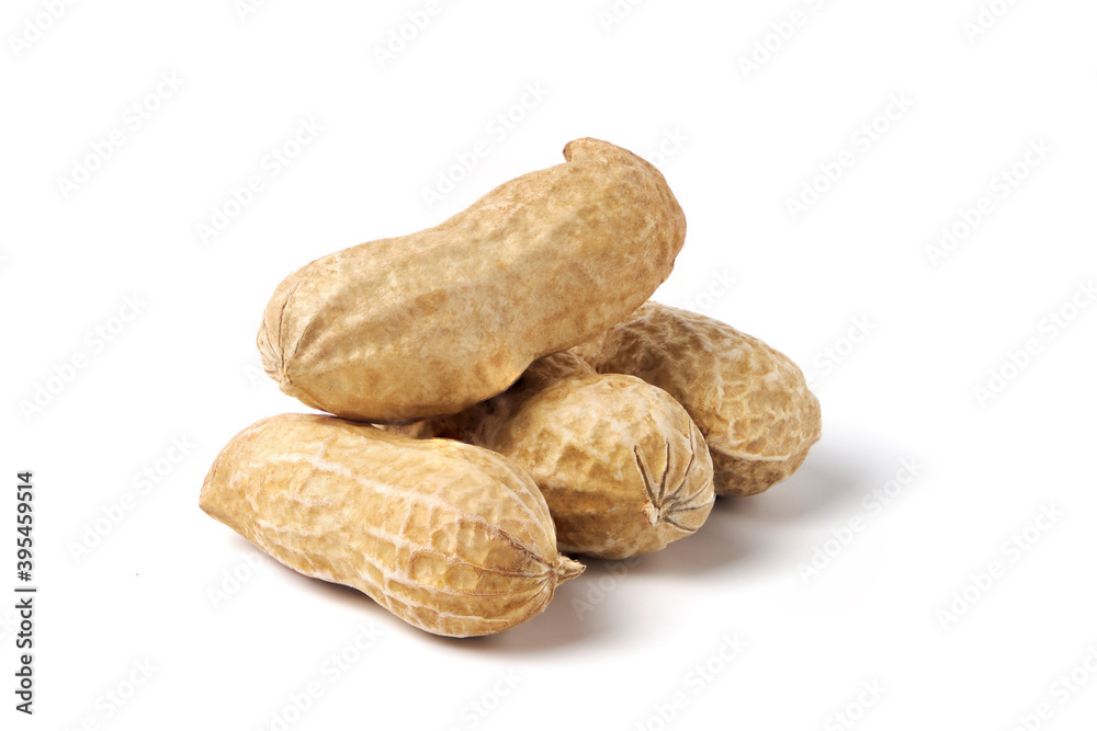 Raw peanuts isolated on white. Heap of groundnuts in a nutshell Raw peanuts isolated on white. Heap of groundnuts in a nutshell
