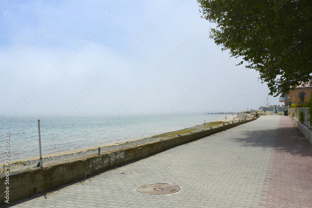 Ravda, Bulgaria. May, 20, 2014. Seashore with white cloud covering water. Promenade edge with no people