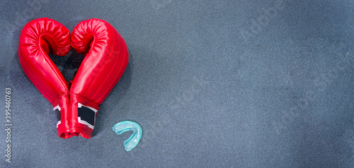 Gym background and fitness equipment and valentine concept. Boxing glove in shape of heart.