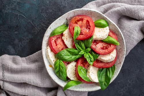 Caprese salad with mozzarella, basil and tomatoes photo