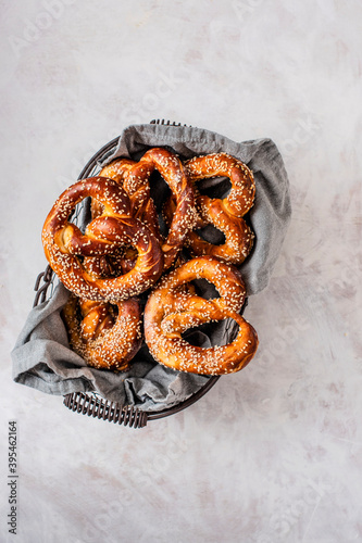 Homemade pretzels with seasme seeds in a wire basket photo