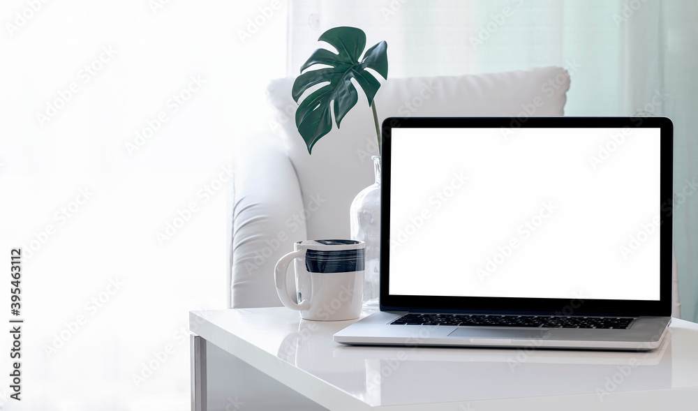 Fototapeta premium Mockup blank screen laptop on coffee table in living room. Copy space.