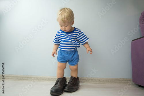 Wallpaper Mural small child, dressed in brown shoes large adult. the child wore dad's shoes Torontodigital.ca
