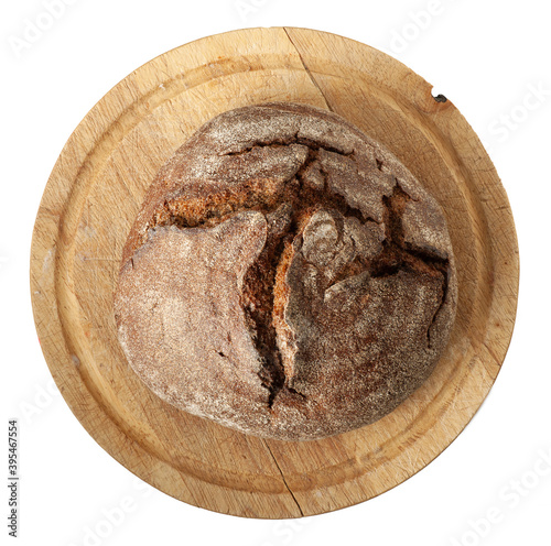 Freshly baked brown bread on cutting board isolated on white background. Flat lay.