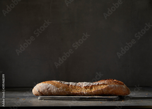 A baguette in front of a dark background