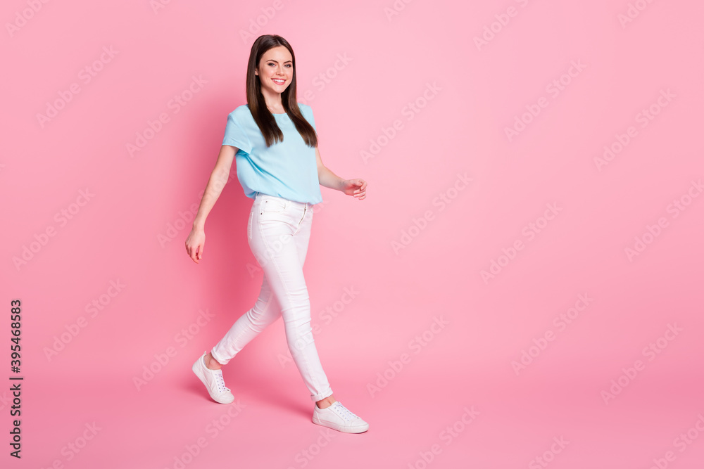Full size profile side photo of nice girl go copyspace isolated over pink color background Full size profile side photo of nice girl go copyspace isolated over pink color background