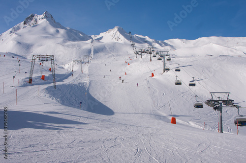 Winter landscape in the Alps. Mayrhofen sports region in the Zillertal. Ski slopes in the background of mountains photo