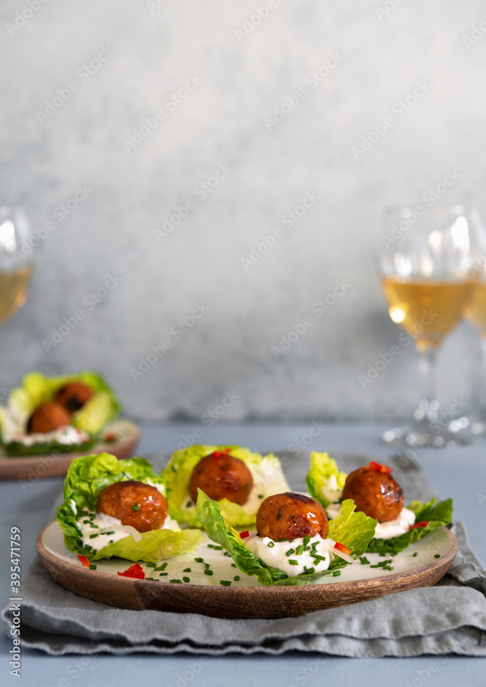 Vegan 'meatballs' served on lettuce leaves