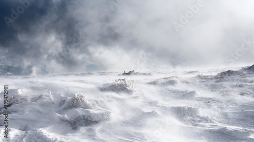 A mountain slope covered with a layer of snow during a blizzard. Trapped in motion. photo
