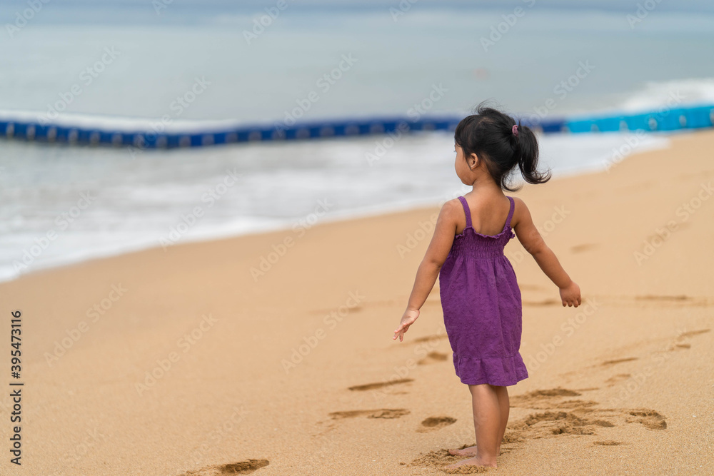 Cute little girl playing on the beach in morning. Cute little girl playing on the beach in morning.
