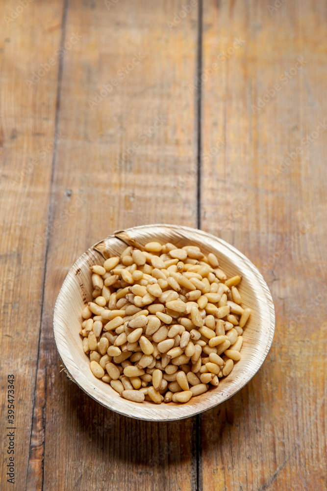 Pine nuts in a wooden bowl Pine nuts in a wooden bowl