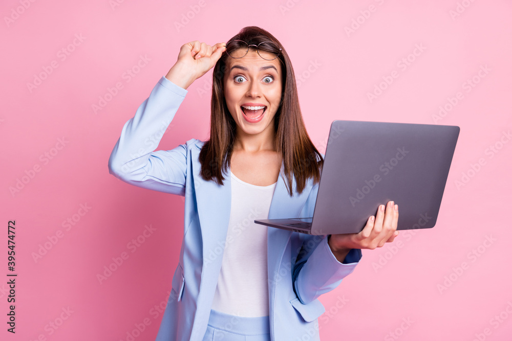 Photo of young girl excited surprised happy smile news discount hold laptop hand touch glasses isolated over pastel color background Photo of young girl excited surprised happy smile news discount hold laptop hand touch glasses isolated over pastel color background
