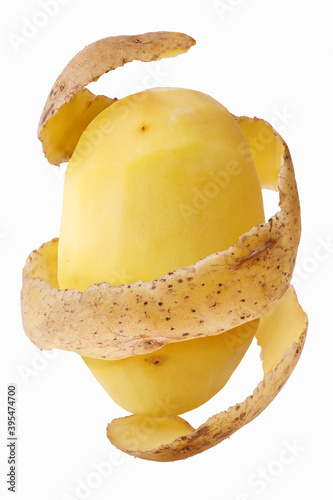 A peeled potato with potato peel