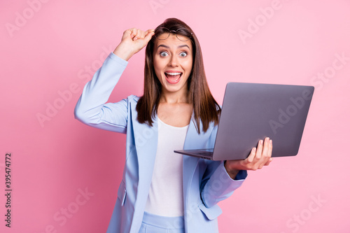 Photo of young girl excited surprised happy smile news discount hold laptop hand touch glasses isolated over pastel color background photo