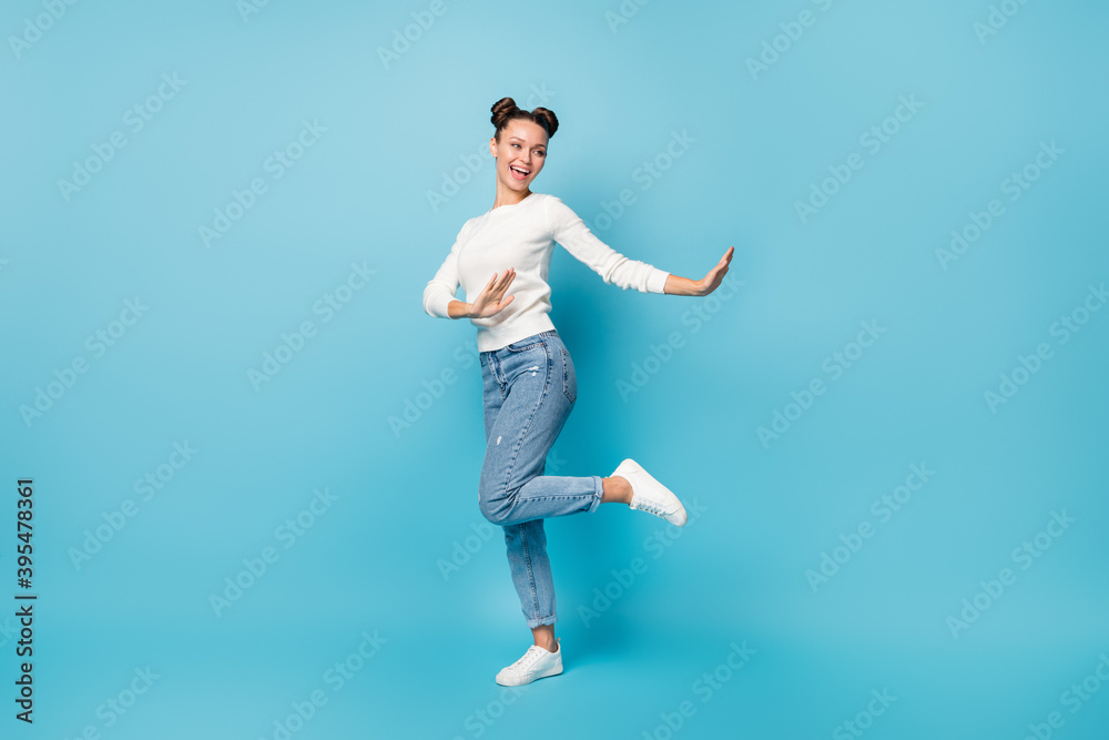 Full length photo of cheerful lady have fun dance wear white pullover jeans sneakers isolated blue color background
