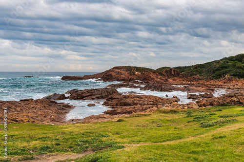 Rocky Seascape with Blue Aquamarine Sea and Earthy Brown Rocks