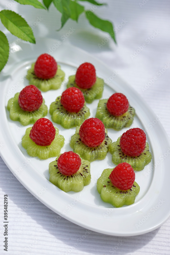 Fruit tapas: kiwi slices with raspberries Fruit tapas: kiwi slices with raspberries