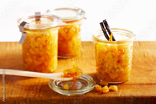 Preserved quince chutney with oranges, vanilla and Malabar pepper in mason jars photo