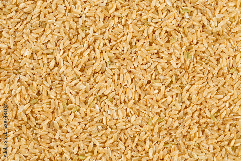 Close up, top down view of raw, whole grain, brown rice.