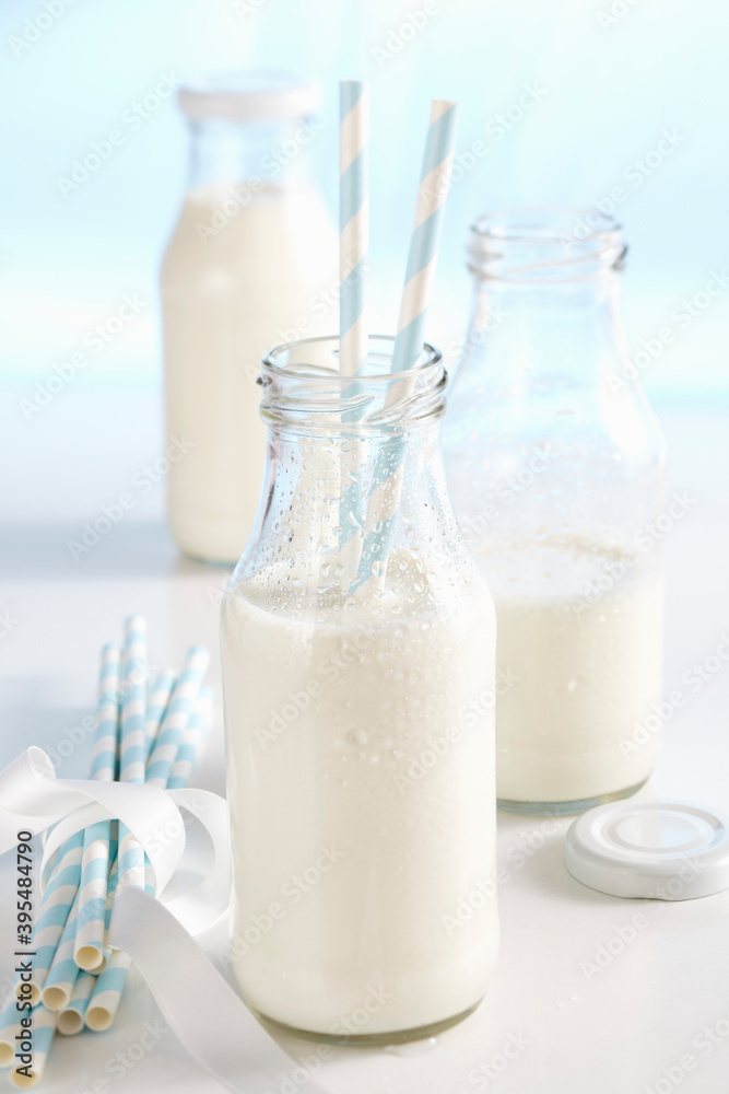 Cold, fresh milk in bottles with straws Cold, fresh milk in bottles with straws