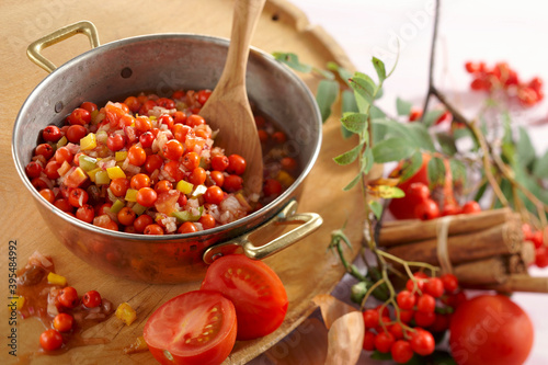 Rowan chutney with tomatoes, peppers and sultanas being made photo