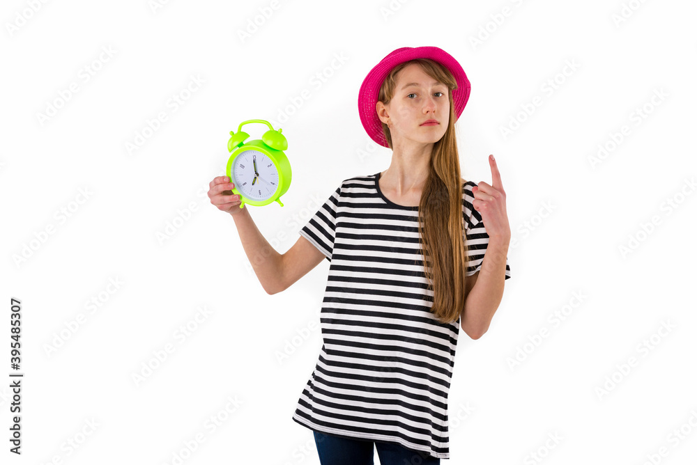 Teen Girl holding alarm Clock, isolated on white background. Portrait of caucasian teenager showing alarm clock. Teen Girl holding alarm Clock, isolated on white background. Portrait of caucasian teenager showing alarm clock.