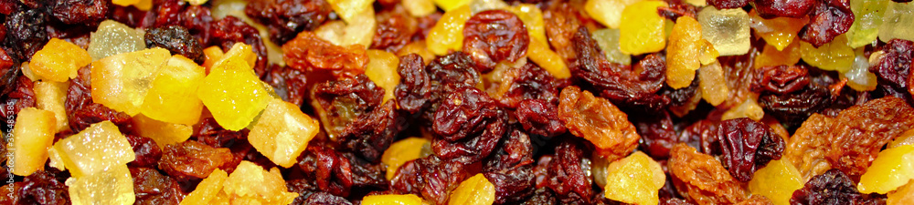 panoramic close up of dried red and yellow raisins, currants, sultanas, mixed orange , lemon and lime peel, and zest, cranberries, and suet . Ingredients for mince meat for pies and Christmas cake. panoramic close up of dried red and yellow raisins, currants, sultanas, mixed orange , lemon and lime peel, and zest, cranberries, and suet . Ingredients for mince meat for pies and Christmas cake.