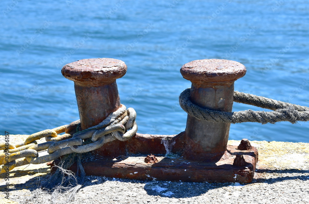 Rusty iron mooring post close-up in a harbor at famous Rias Baixas in Galicia Region. Spain.
