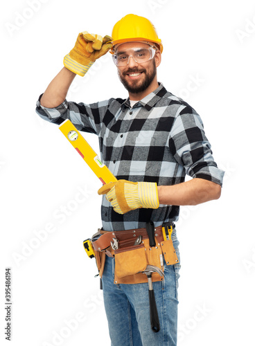 profession, construction and building - happy smiling male worker or builder in helmet with level over white background